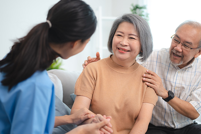 Hospice specialist speaking with an older couple